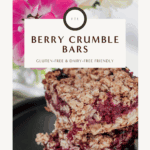Golden brown gluten-free berry crumble bars stacked on a plate, topped with fresh berries - perfect for brunch, dessert, or a coffee break.