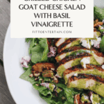 Overhead image of grilled chicken goat cheese salad with mixed greens, grilled seasonal fruit, toasted pecans, and a drizzle of homemade basil vinaigrette on a white plate.
