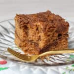 A golden slice of gluten-free cinnamon streusel coffee cake on a plate, topped with crumbly coconut sugar streusel and served with a cup of coffee. Ideal for brunch or a cozy weekend bake.