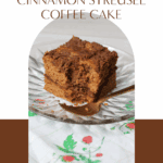 A golden slice of gluten-free cinnamon streusel coffee cake on a plate, topped with crumbly coconut sugar streusel and served with a cup of coffee. Ideal for brunch or a cozy weekend bake.