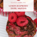 Close-up of three lemon raspberry swirl muffins topped with fresh raspberries, styled on a white plate with lemon slices in the background.