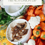 A creamy gluten- and dairy-free French onion dip made from cashews, topped with caramelized onions and surrounded by colorful crudité.