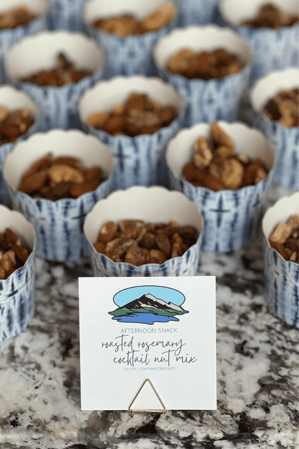 Mini decorative disposable cups of rosemary cocktail nut mix - perfect for entertaining.