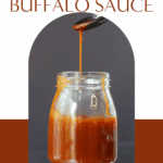 Homemade buffalo sauce pouring into jar, spicy wing sauce, fresh ingredients, bold flavor.