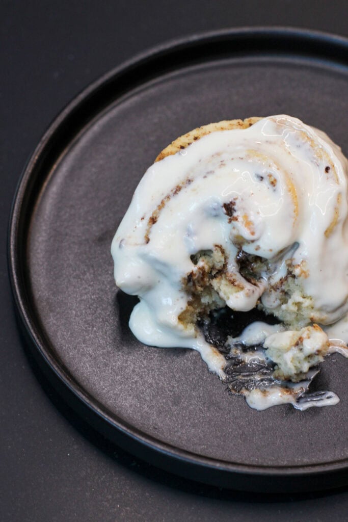 Soft gluten-free cinnamon rolls topped with cream cheese icing, fresh from the oven.