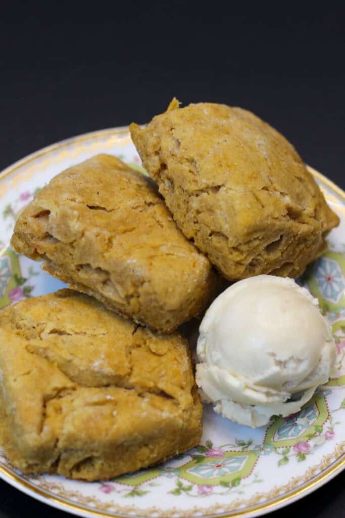 Mini sweet potato biscuits on a plate served with whipped maple butter - golden, fluffy, and perfect for entertaining.