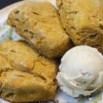 Mini sweet potato biscuits on a plate served with whipped maple butter - golden, fluffy, and perfect for entertaining.