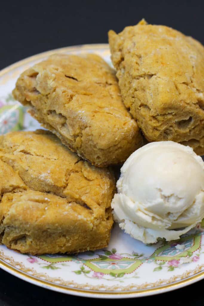 Mini sweet potato biscuits on a plate served with whipped maple butter - golden, fluffy, and perfect for entertaining.