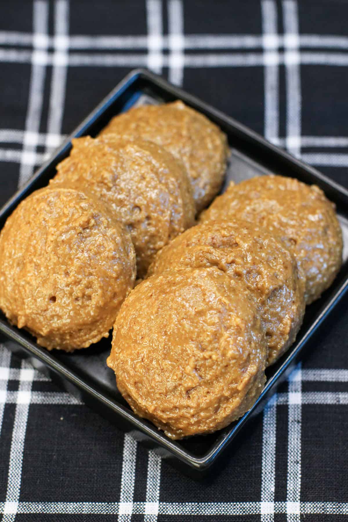 Cinnamon roll protein bites made with almond flour and cinnamon, arranged on a serving dish.