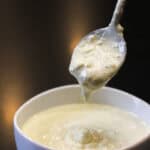 Creamy homemade blue cheese dressing in a white bowl with spoon
