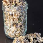 Crunchy ancient grain granola with oats, chia seeds, pumpkin seeds, and shredded coconut in a glass jar