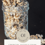 Crunchy ancient grain granola with oats, chia seeds, pumpkin seeds, and shredded coconut in a glass jar