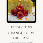 Slice of orange olive oil cake topped with whipped honey ricotta, fresh raspberries, and citrus zest on a dark plate