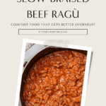 Slow-braised beef ragù simmering in a cast iron Dutch oven, with tender shredded beef in a rich tomato and red wine sauce.