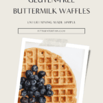 Golden gluten-free buttermilk waffle topped with fresh blueberries and maple syrup, styled on a white plate for a clean, minimal breakfast presentation.