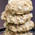 Stack of chewy high carb oatmeal cookies on a black plate, made with rolled oats and designed as homemade endurance fuel for cyclists and long training days.