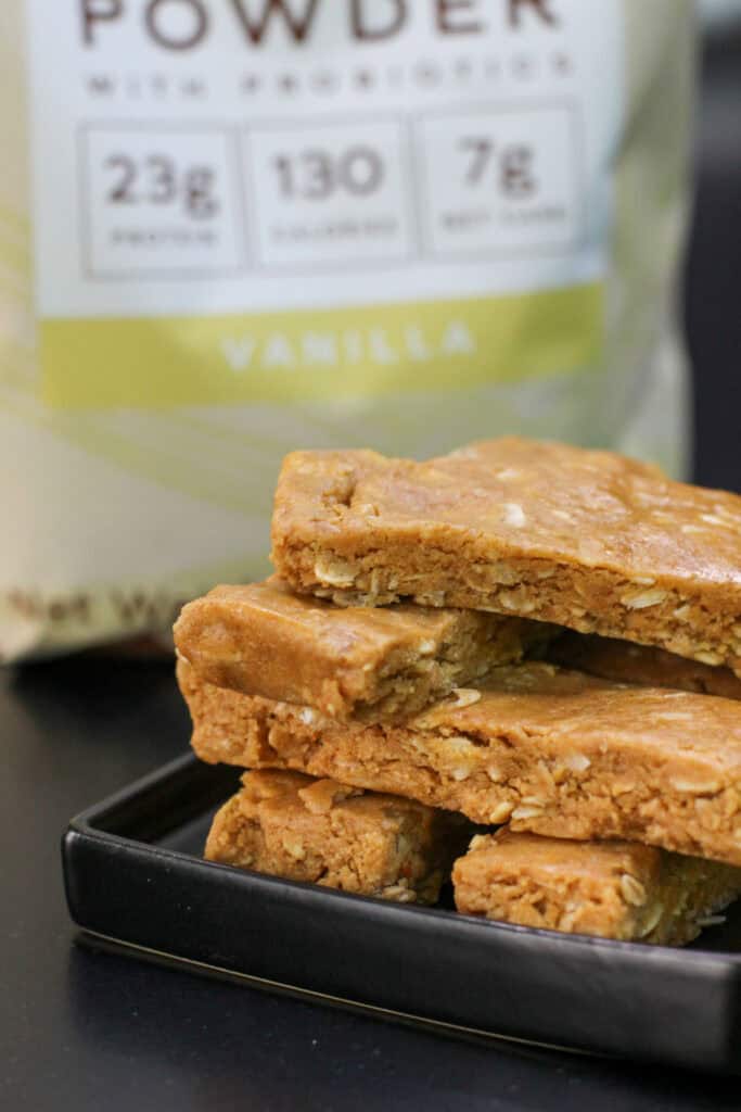 Close-up of homemade peanut butter protein bars made with oats, peanut butter, honey, and vanilla protein powder, highlighting their chewy texture.